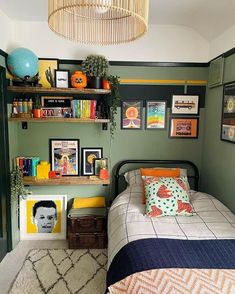 a bed room with a neatly made bed and lots of pictures on the wall above it