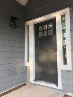 the front door of a gray house with white trim