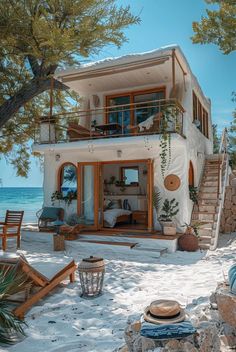 a house on the beach with stairs leading up to it