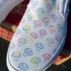 Check out our rave trippy mushroom custom design on White Slip On Vans. This pattern of colorful and funky mushrooms have a theme of bright rainbow color on the tops of these slip on vans shoes. We buy each pair of shoes BRAND NEW. Each pair is made to order, please make sure you put in the correct shoe size before you check out. The ink is permanent and will never come off, fade away, or peel off. Made in the USA. This price includes everything: shoes and artwork. Each pair of shoes is made-to- Mushroom Shoes Painted, Diy Shoe Painting Ideas Easy, Painted Vans Slip On, Vans Painted Shoes Ideas, Mushroom Shoes, Funky Mushrooms, Upcycle Shoes, Vans Painted, White Slip On Vans