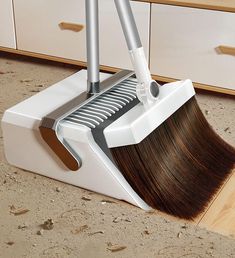 a broom is laying on the floor with it's brush