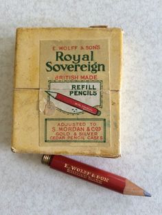 an old matchbox with a pencil on it