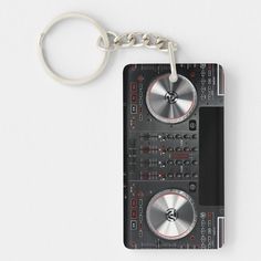 a keychain with a dj's turntable on it is shown in front of a white background