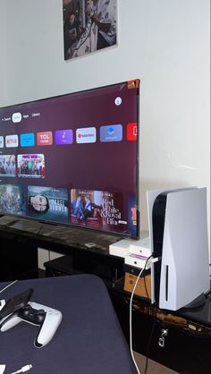 a flat screen tv sitting on top of a wooden table