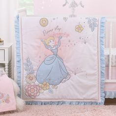 a baby crib with a princess bedding set