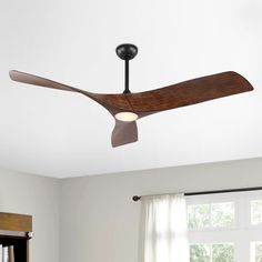 a ceiling fan that is hanging from the ceiling in a room with white walls and windows