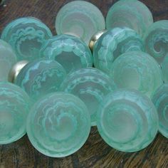 green glass bowls sitting on top of a wooden table