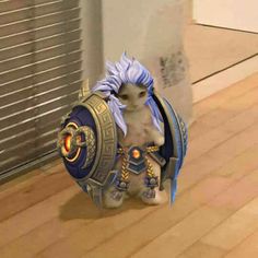 a cat dressed up as a character from the video game overwatch sitting on top of a hard wood floor