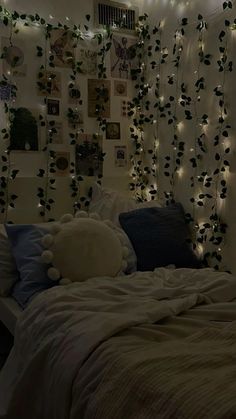 a bed with pillows and lights on the wall