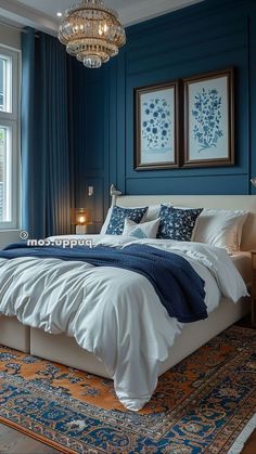 a bedroom with blue walls, white bedding and a chandelier hanging from the ceiling