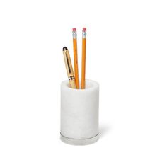 three pencils and two pens in a white cup