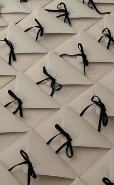 many pieces of paper with black ribbon tied to them