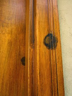 an old wooden door with two black knobs