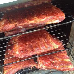 three ribs cooking in an oven on racks