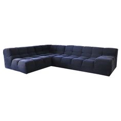 a large blue sectional couch on a white background