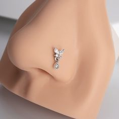 a close up view of an earring on a mannequin