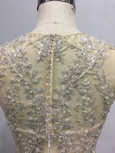 the back of a dress with beading and sequins