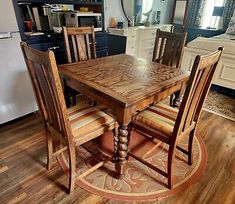 a wooden table and chairs in a room