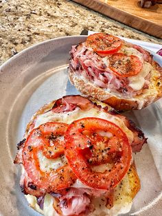 two slices of bread with tomatoes and meat on them