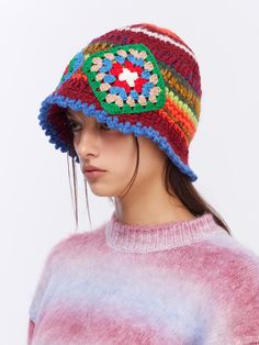 a woman wearing a multicolored crocheted hat