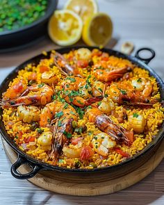 a pan filled with shrimp and rice on top of a table