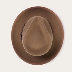 An icon of the Stetson brand, the Whippet Fedora epitomizes the sophisticated style of the American post-war era with its timeless, versatile profile and a brim that can look casual and cool when snapped up, or snapped down for a dressed-up and dapper look. Handcrafted with a firm finish from high-quality 100% wool felt and richly dyed in versatile shades, the Whippet features a slightly tapered 4 ½" pinch front teardrop crown and a 2 ⅜” bound edge brim. Its classic style is underscored by a gro Classic Brown Felt Hat With Flat Crown, Classic Curved Brim Felt Hat For Fall, Classic Felt Hat With Curved Brim For Fall, Brown Fedora For Kentucky Derby And Formal Occasions, Flat Crown Fur Felt Fedora, Classic Panama Hat With Curved Brim For Fall, Classic Fedora With Curved Brim For Fall, Classic Wide Brim Felt Hat For Fall, Classic Curved Brim Fedora For Fall