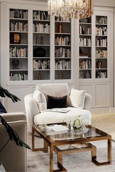 a living room filled with furniture and a chandelier