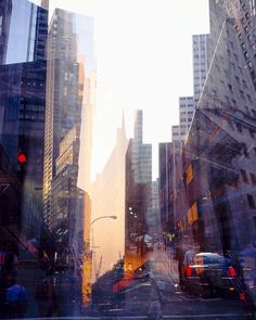 a city street filled with lots of tall buildings and traffic lights in the middle of it