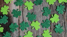 green glitter shamrocks are arranged on a wooden surface