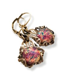 Hand crafted Art Deco Era, Lalique style inspiration, glass fire opal earrings. The stones have a pink base, with highlights of gold, aqua, green and red. When they catch the light, they seem to glow with fire from within.  I hand sculpted the filigree setting for them.  * Drop approx. .75" L x 5/8" W (19mm L x 16mm W)   *   Full length including ear wires approx. 1.5" L (33mm L)  * Finish: Antique gold-tone patina on solid brass.  * Stone: Glass fire opals are premium quality unworn vintage stock, Artisan made in Czechoslovakia.  * Solid brass hand forged ear wires * All metal components are high quality solid brass, lead and nickel free. * Packaged in a beautifully presented gift box with organza ribbons ready for gifting Limited Availability: Each piece is handcrafted and unique, availa Artistic Handmade Jewelry For Celebration, Vintage Iridescent Earrings For Gift, Nickel-free Art Nouveau Earrings As Gift, Artistic Czech Glass Earrings For Gifts, Artistic Czech Glass Earrings Gift, Artistic Czech Glass Jewelry For Gifts, Artistic Design Jewelry For Party, Artistic Jewelry For Party, Handmade Art Nouveau Drop Earrings Jewelry