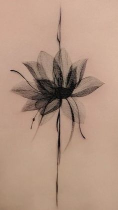 a black and white photo of a flower on the back of a woman's shoulder