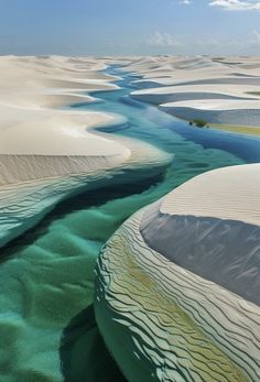 an aerial view of the water and sand dunes