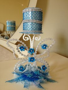 there is a cake that has been made to look like a butterfly with blue flowers on it