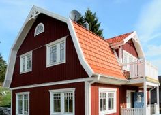 a red house with white trim and windows