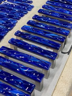 several blue glass benches lined up on the floor