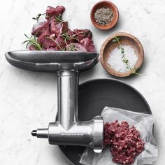 the meat grinder is next to some ingredients