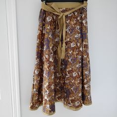 Beautiful Long Wrap Skirt From Shinawatra (The Oldest Silk Factory In Thailand). Pattern In Shades Of Purple, Yellow-Orange, And Brown. 100% Silk. No Size Listed But Would Fit S/M. Bohemian Orange Skirted Bottoms, Orange Bohemian Skirted Bottoms, Bohemian Orange Skirt With Elastic Waistband, Orange Bohemian Skirt With Elastic Waistband, Bohemian Orange Lined Skirt, Long Wrap Skirt, Shades Of Purple, Yellow Orange, Wrap Skirt