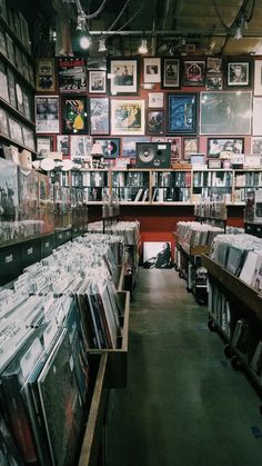 a room filled with lots of cd's and cdshelves covered in pictures