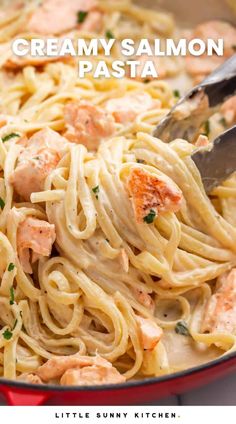 creamy salmon pasta in a red skillet with a serving spoon and title overlay