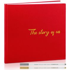 the story of us is written on a red book with two pencils next to it