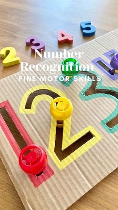 the number recognition fine motor skills are made out of construction paper and colored plastic letters