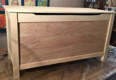 a wooden chest sitting on top of a hard wood floor