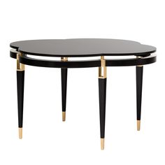 two tables with black and gold legs on each side, one is shaped like an oval table