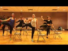 a group of young women standing on top of chairs in a dance studio with their legs spread out