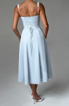 Must-have milkmaid midis are what we're wearing ALL season with sleek waves and mule heels. Ulrika has underwired cups. fan shape straps and a boned corset for a snatched waist. With a lace up back to make this extra figure flattering. it's complemented with a full skirt and thigh high split.   Colour: Blue. Premium non-stretch cotton blend fabric. Fully lined. Underwired bust. Fan shape. adjustable straps. Lace trim detail. Waist cinching. corset style bodice with boning. Tie to bust. Voluminou Sleek Waves, Skirt And Thigh Highs, Homecoming Dresses Corset, White Dress Spring, Snatched Waist, Long Sleeve Bridesmaid Dress, Long Sleeve Homecoming Dresses, Mule Heels, Ditsy Print