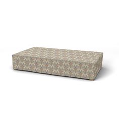 an upholstered ottoman with multicolored circles on it, sitting in front of a white background