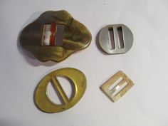 three different types of metal buckles on a white surface