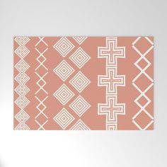 an orange and white area rug with geometric designs on the front, back and sides