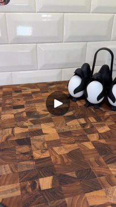 two black and white balls sitting on top of a cutting board