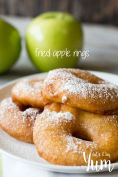 some sugar covered donuts on a white plate next to green apples and the words, fried apple rings